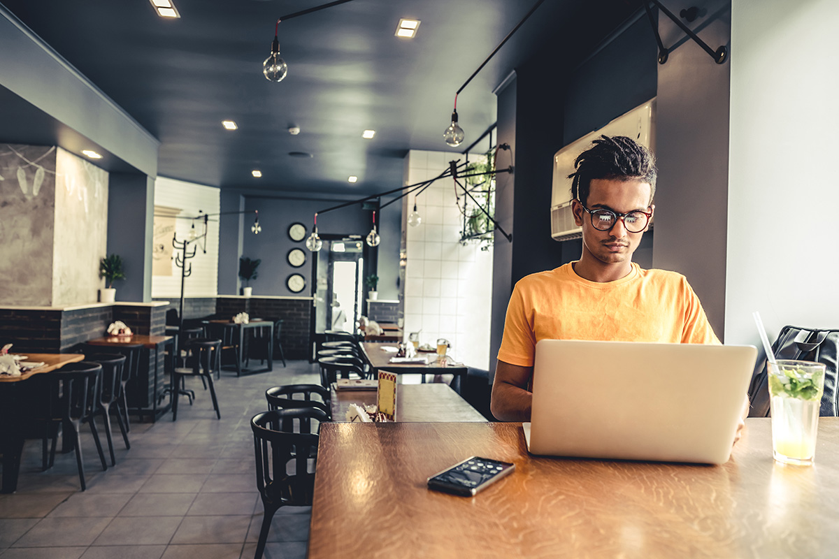 Man doing freelance work in a cafe