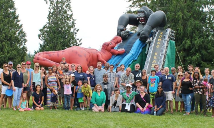 DreamBox Learning team members hanging out at a park together with a giant inflatable slide 