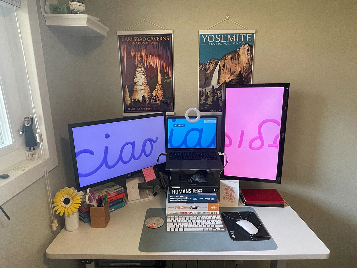 Flexe team member's home office workspace with multiple monitors, books and travel posters