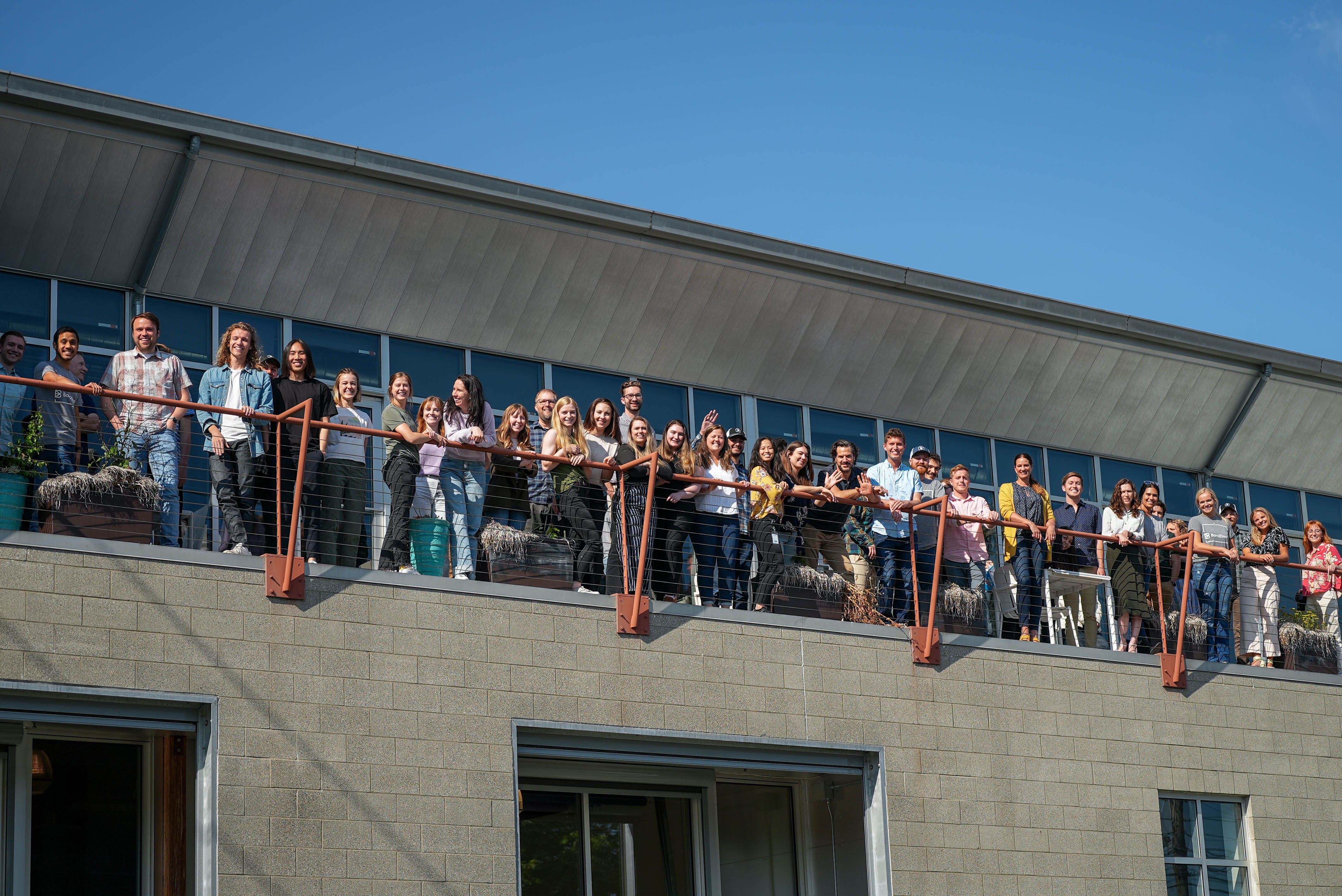 barn2door's employees pose in a group picture on a balcony