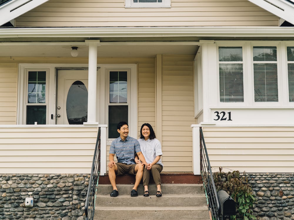 A couple sitting on the porch of a home they bought using Flyhomes