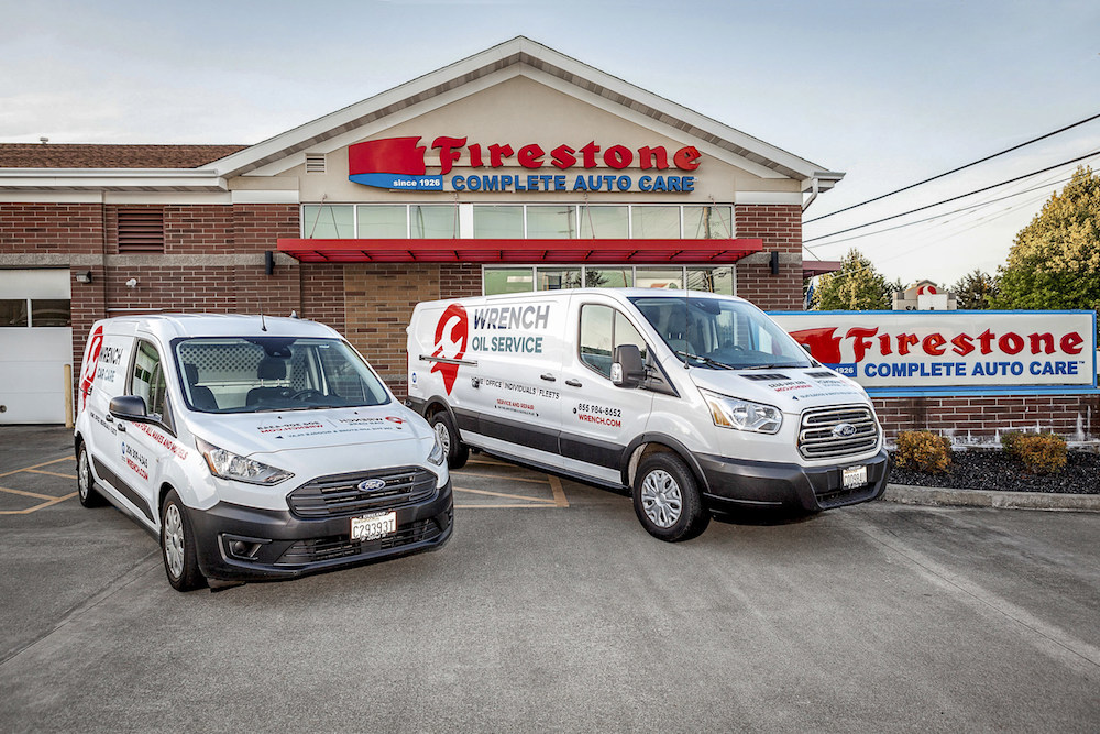 Wrench mechanic vans in front of Firestone auto shop.