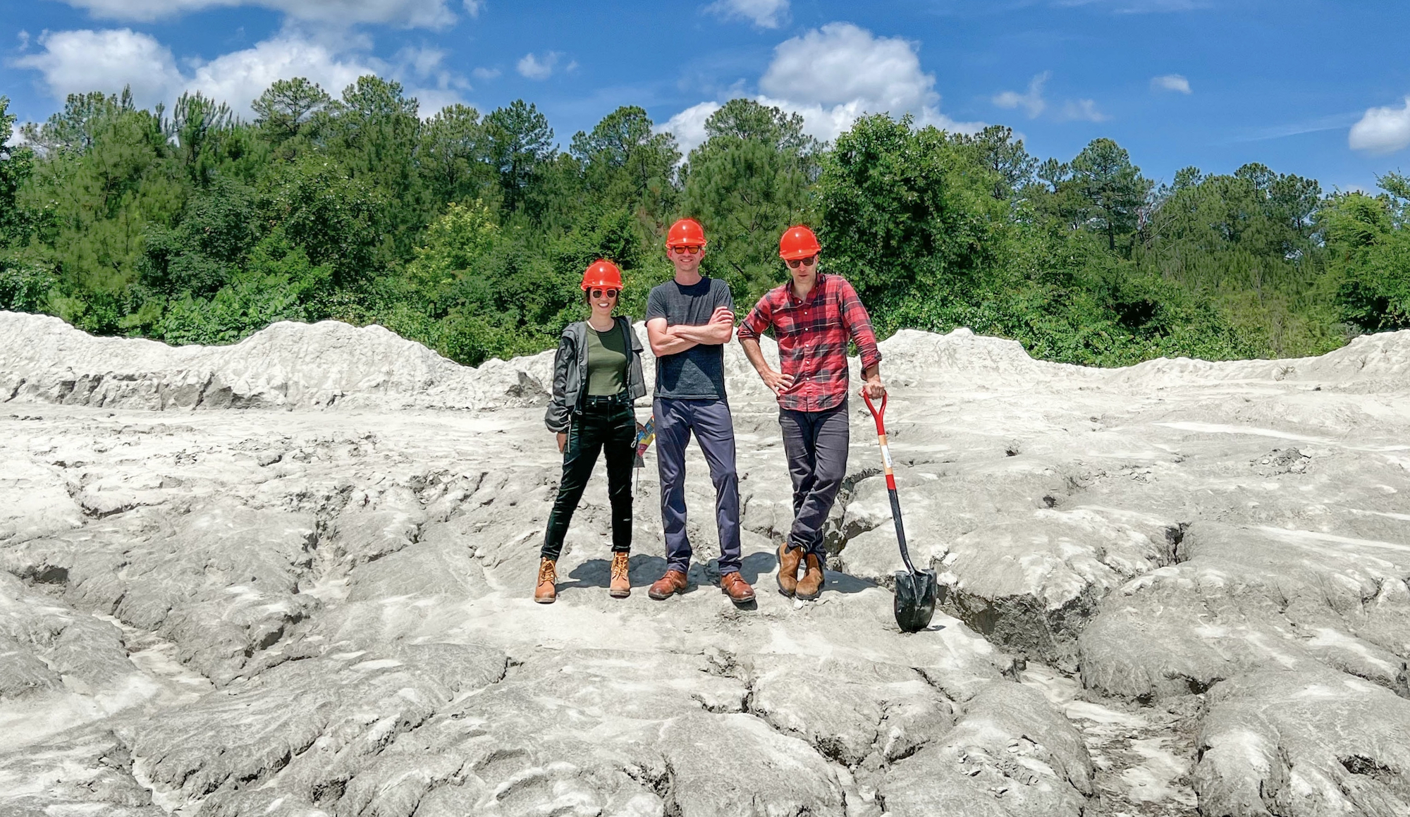 The Lithos founding team standing atop a rocky deposit