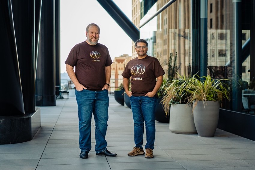 Oleria co-founders Jim Alkove (left) and Jagadeesh Kunda (right) stand next to each other outside a building.