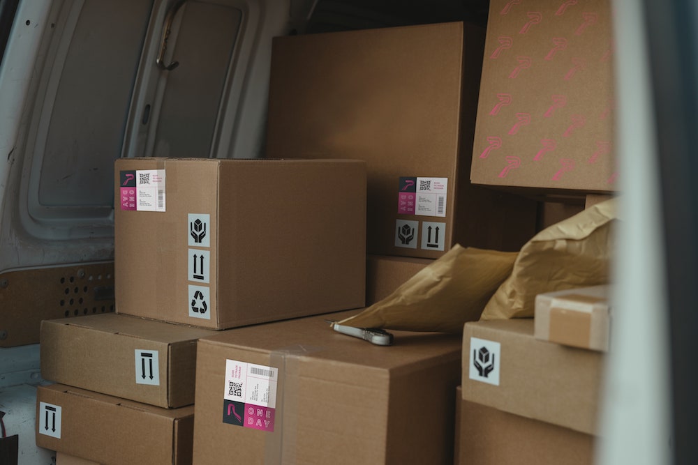 cardboard boxes with Pandion logo in delivery truck