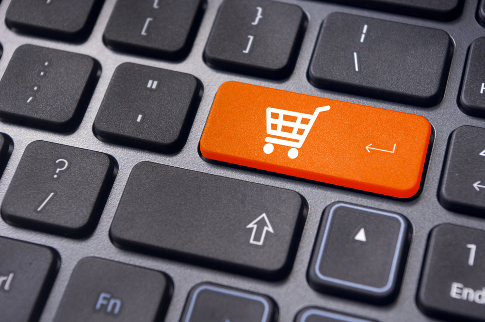 orange shopping cart button on a laptop keyboard