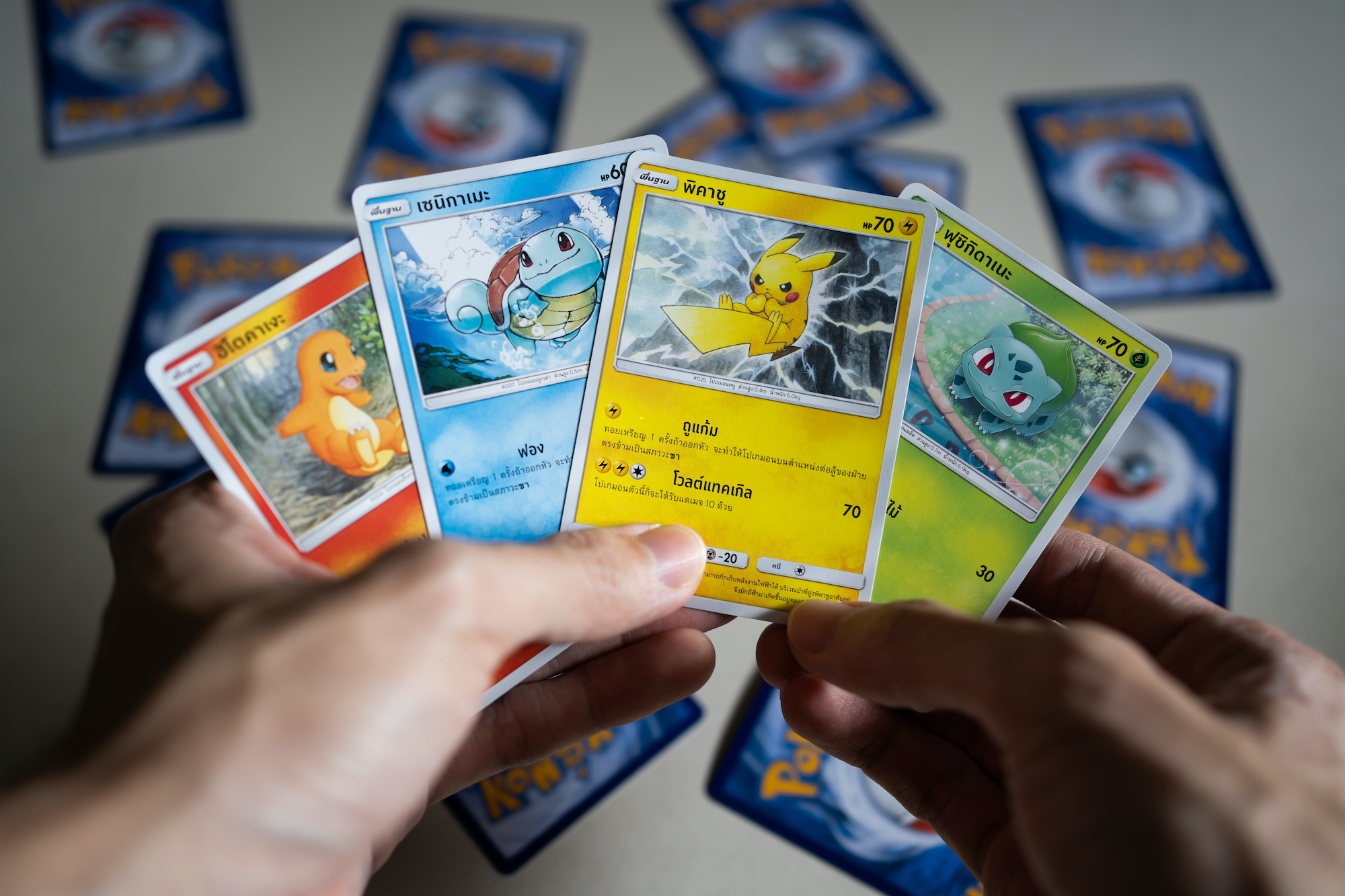 Pokemon cards in hand