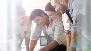 A group of sales reps during a sales meeting.
