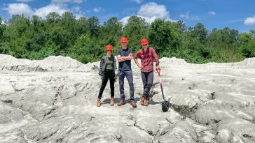 The Lithos founding team standing atop a rocky deposit