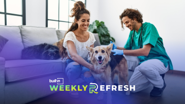 People petting a dog in a living room.