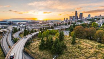 A birds eye view of expressways and the Seattle skyline.
