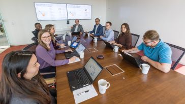 ZS team members around conference table in meeting