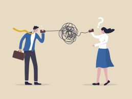 A man speaks through a can attached to a wire to a woman. The wire in between them is extremely tangled and knotted, causing the message to come through garbled in a way that confuses the woman.